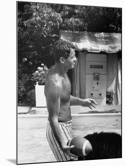Attorney General Robert F. Kennedy Holding Football, with Dog Nearby, at His Swimming Pool-null-Mounted Photographic Print