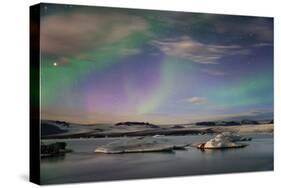 Aurora borealis (Northern Lights) over Jokulsarlon Glacial Lagoon, Iceland, Polar Regions-Miles Ertman-Stretched Canvas