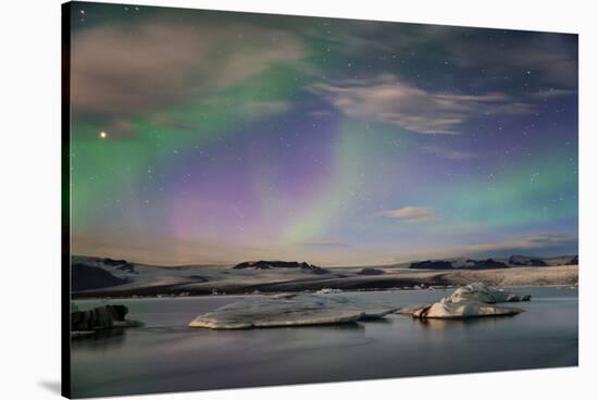 Aurora borealis (Northern Lights) over Jokulsarlon Glacial Lagoon, Iceland, Polar Regions-Miles Ertman-Stretched Canvas