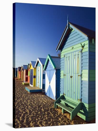 Australia, Victoria, Melbourne; Colourful Beach Huts at Brighton Beach-Andrew Watson-Stretched Canvas
