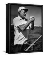 Author Ernest Hemingway at Wheel of Fishing Boat During Fishing Tournament-Alfred Eisenstaedt-Framed Stretched Canvas