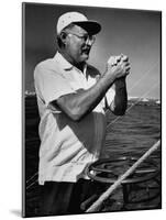 Author Ernest Hemingway at Wheel of Fishing Boat During Fishing Tournament-Alfred Eisenstaedt-Mounted Premium Photographic Print