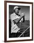 Author Ernest Hemingway at Wheel of Fishing Boat During Fishing Tournament-Alfred Eisenstaedt-Framed Premium Photographic Print