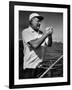 Author Ernest Hemingway at Wheel of Fishing Boat During Fishing Tournament-Alfred Eisenstaedt-Framed Premium Photographic Print