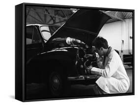 Auto Electrician Changing a Light Bulb on a Morris Minor, Nottingham, Nottinghamshire, 1961-Michael Walters-Framed Stretched Canvas