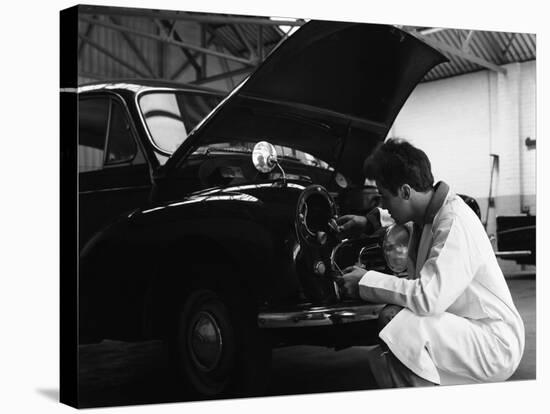 Auto Electrician Changing a Light Bulb on a Morris Minor, Nottingham, Nottinghamshire, 1961-Michael Walters-Stretched Canvas