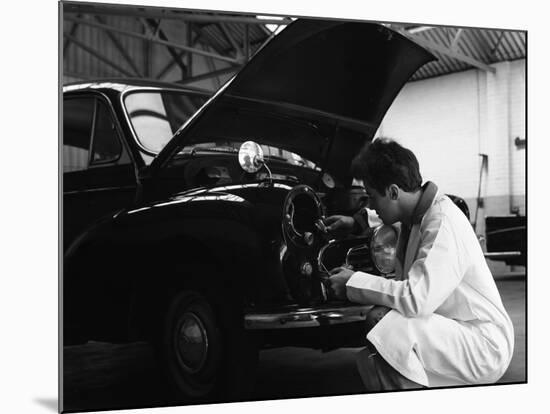 Auto Electrician Changing a Light Bulb on a Morris Minor, Nottingham, Nottinghamshire, 1961-Michael Walters-Mounted Photographic Print