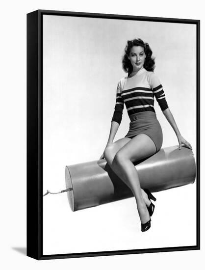 Ava Gardner seated on Giant firecracker, c. 1945 (b/w photo)-null-Framed Stretched Canvas