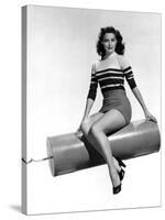 Ava Gardner seated on Giant firecracker, c. 1945 (b/w photo)-null-Stretched Canvas