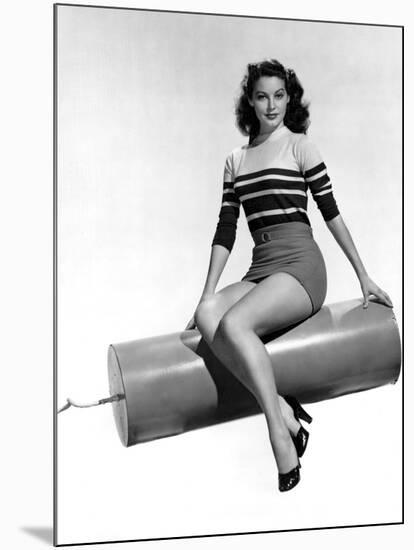 Ava Gardner seated on Giant firecracker, c. 1945 (b/w photo)-null-Mounted Photo