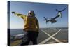 Aviation Boatswain's Mate Directs an MV-22 Osprey as it Launches from the Flight Deck-null-Stretched Canvas