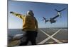 Aviation Boatswain's Mate Directs an MV-22 Osprey as it Launches from the Flight Deck-null-Mounted Premium Photographic Print