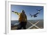 Aviation Boatswain's Mate Directs an MV-22 Osprey as it Launches from the Flight Deck-null-Framed Photographic Print