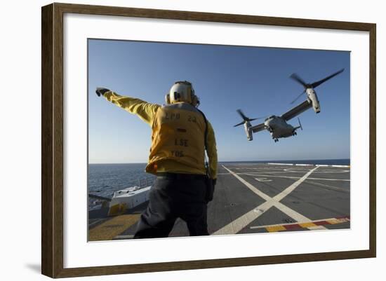 Aviation Boatswain's Mate Directs an MV-22 Osprey as it Launches from the Flight Deck-null-Framed Photographic Print