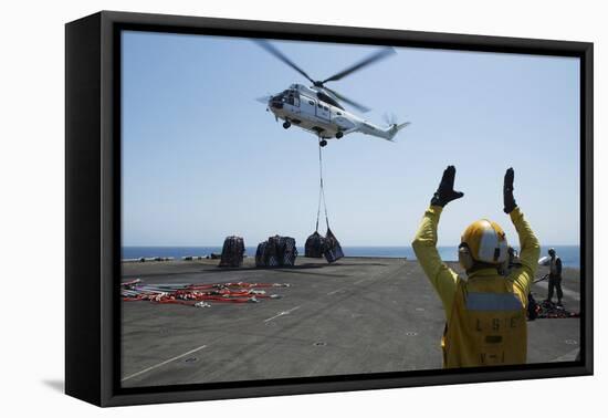 Aviation Boatswain's Mate Directs an SA-330J Puma Helicopter-null-Framed Stretched Canvas