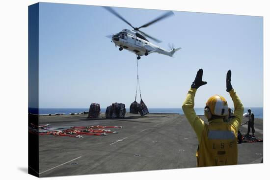 Aviation Boatswain's Mate Directs an SA-330J Puma Helicopter-null-Stretched Canvas