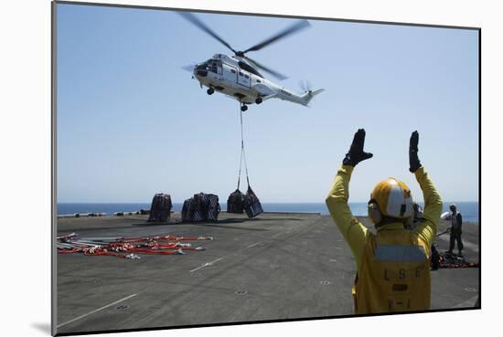 Aviation Boatswain's Mate Directs an SA-330J Puma Helicopter-null-Mounted Photographic Print