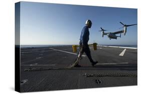 Aviation Boatswain's Mate Prepares to Chock and Chain an MV-22 Osprey-null-Stretched Canvas