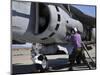 Aviation Fuel Technician Attaches a Fuel Line to an Av-8B Harrier-null-Mounted Photographic Print