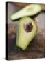 Avocado, Halved, on Old Chopping Board-Jo Kirchherr-Stretched Canvas