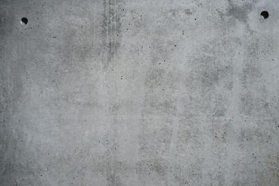 Concrete grey wall with structure and inclusions as a background