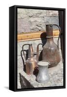 Azerbaijan, Lahic. A copper kettle and jug sitting outside a residence.-Alida Latham-Framed Stretched Canvas