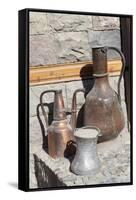 Azerbaijan, Lahic. A copper kettle and jug sitting outside a residence.-Alida Latham-Framed Stretched Canvas