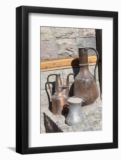 Azerbaijan, Lahic. A copper kettle and jug sitting outside a residence.-Alida Latham-Framed Photographic Print