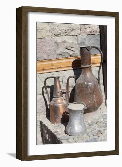 Azerbaijan, Lahic. A copper kettle and jug sitting outside a residence.-Alida Latham-Framed Photographic Print