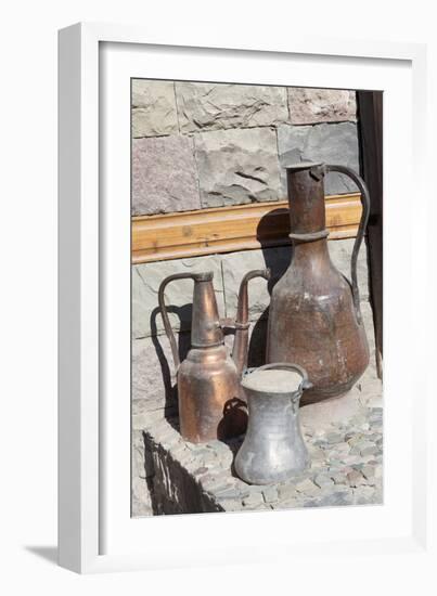 Azerbaijan, Lahic. A copper kettle and jug sitting outside a residence.-Alida Latham-Framed Photographic Print