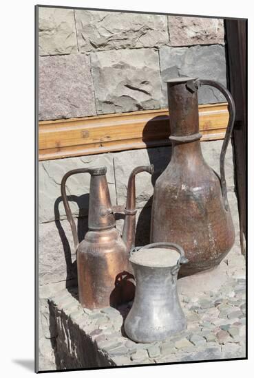 Azerbaijan, Lahic. A copper kettle and jug sitting outside a residence.-Alida Latham-Mounted Photographic Print