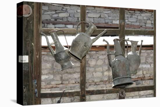 Azerbaijan, Lahic. Antique kettles hanging on the inside of a window.-Alida Latham-Stretched Canvas