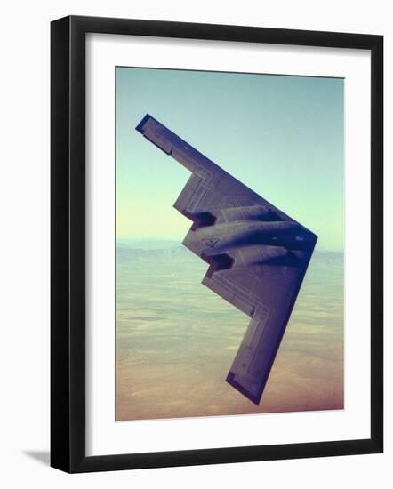 B-2 Stealth Bomber Flying over Desert-Like Landscape-null-Framed Premium Photographic Print