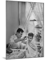 B.F. Goodrich Engineer Frank Herzegh Developed the Tubeless Tire, Cutting his son Frankie's hair-Alfred Eisenstaedt-Mounted Photographic Print