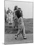 Babe Didrikson, Watching Golf Ball as She Completes Her Swing-null-Mounted Photo