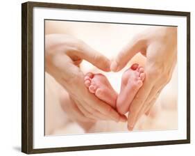 Baby Feet in Mother Hands. Tiny Newborn Baby's Feet on Female Heart Shaped Hands Closeup. Mom and H-Subbotina Anna-Framed Photographic Print