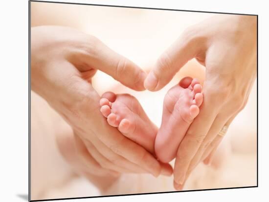 Baby Feet in Mother Hands. Tiny Newborn Baby's Feet on Female Heart Shaped Hands Closeup. Mom and H-Subbotina Anna-Mounted Photographic Print