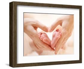 Baby Feet in Mother Hands. Tiny Newborn Baby's Feet on Female Heart Shaped Hands Closeup. Mom and H-Subbotina Anna-Framed Photographic Print