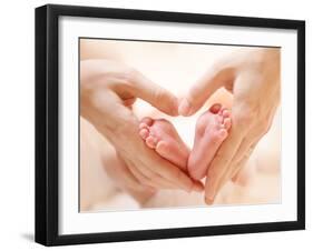 Baby Feet in Mother Hands. Tiny Newborn Baby's Feet on Female Heart Shaped Hands Closeup. Mom and H-Subbotina Anna-Framed Photographic Print