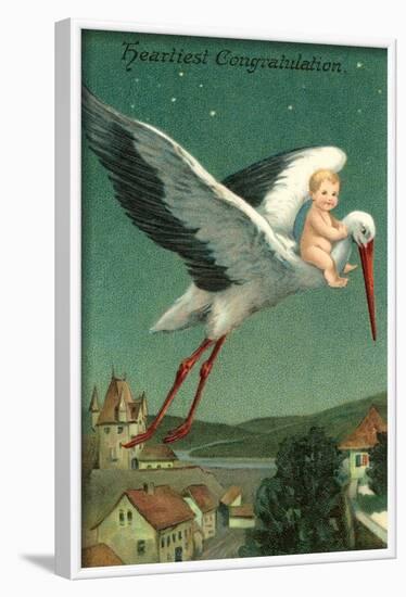 Baby Riding Stork over European Town-null-Framed Art Print