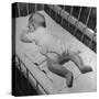 Baby Sleeping on its Stomach in Nursery at St. Vincent's Hospital-Nina Leen-Stretched Canvas
