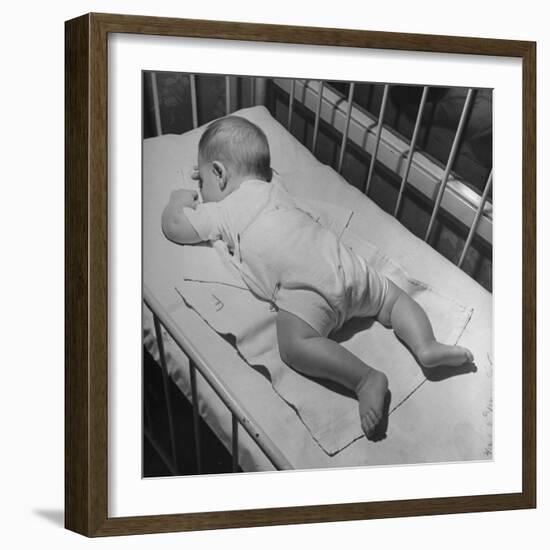 Baby Sleeping on its Stomach in Nursery at St. Vincent's Hospital-Nina Leen-Framed Photographic Print
