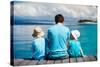 Back View of Father and Kids Sitting on Wooden Dock Looking to Ocean-BlueOrange Studio-Stretched Canvas