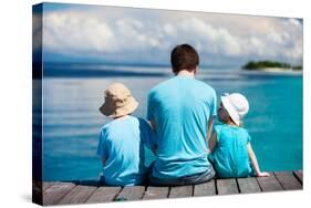 Back View of Father and Kids Sitting on Wooden Dock Looking to Ocean-BlueOrange Studio-Stretched Canvas