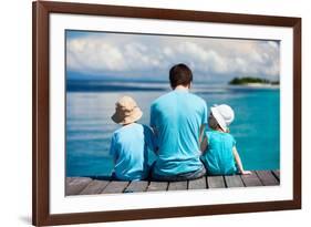 Back View of Father and Kids Sitting on Wooden Dock Looking to Ocean-BlueOrange Studio-Framed Photographic Print