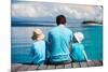 Back View of Father and Kids Sitting on Wooden Dock Looking to Ocean-BlueOrange Studio-Mounted Photographic Print