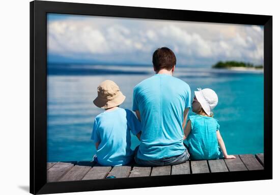 Back View of Father and Kids Sitting on Wooden Dock Looking to Ocean-BlueOrange Studio-Framed Photographic Print