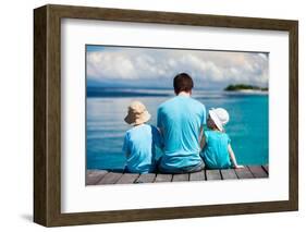 Back View of Father and Kids Sitting on Wooden Dock Looking to Ocean-BlueOrange Studio-Framed Photographic Print