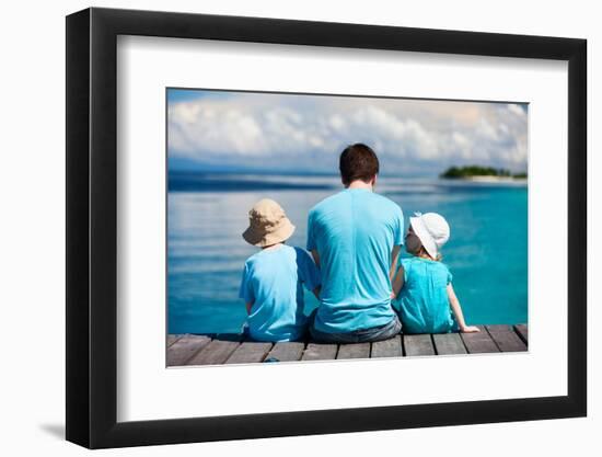 Back View of Father and Kids Sitting on Wooden Dock Looking to Ocean-BlueOrange Studio-Framed Photographic Print