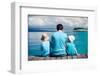 Back View of Father and Kids Sitting on Wooden Dock Looking to Ocean-BlueOrange Studio-Framed Photographic Print